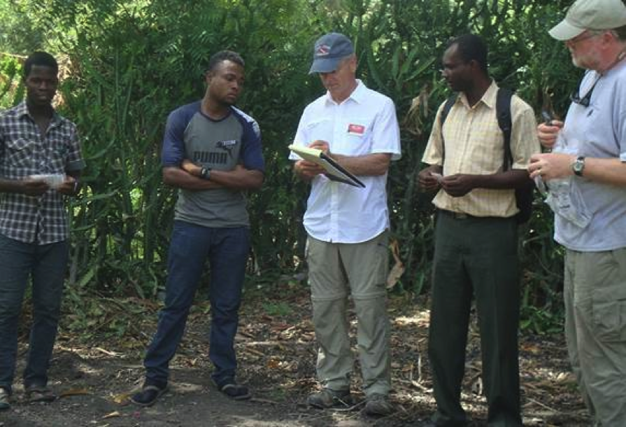 From left: Libonet with seed packets, interpreter Kerly, Ron, Haitian agronomist John Robert, and HFH board member Steve Bressler. 